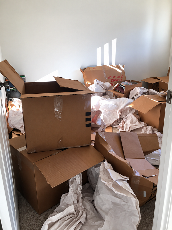 Sunlit Room Filled with Moving Boxes