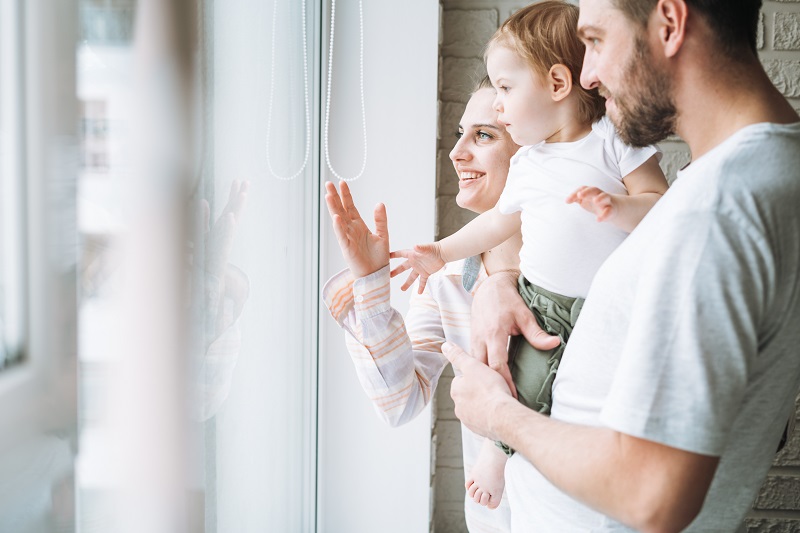 family looking out a window