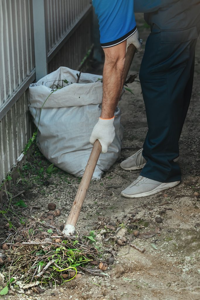 cleaning debris with shuffle in backyard